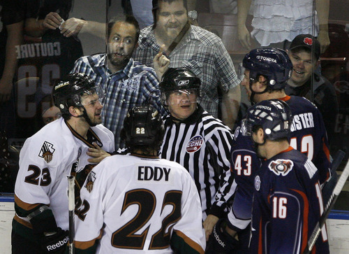 Scott Sommerdorf   |  The Salt Lake Tribune
"Don't make me come over there." Grizzlies fans give Ontario Reign defensemean Matt Register some lip as the referee separates fighting players during second period play. After a scoreless second period, the Utah Grizzlies led the Ontario Reign 1-0 on forward Chris Donovan's first period penalty shot goal in Game 3 of the ECHL playoffs at the Maverick Center, Friday, April 5, 2013.