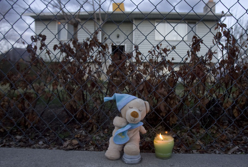 Kim Raff  |  The Salt Lake Tribune
A stuffed animal and candle sit outside of a house at 582 North 500 East where Joshua Petersen is suspected of murdering of his 5-month-old son Ryker in American Fork on Friday.