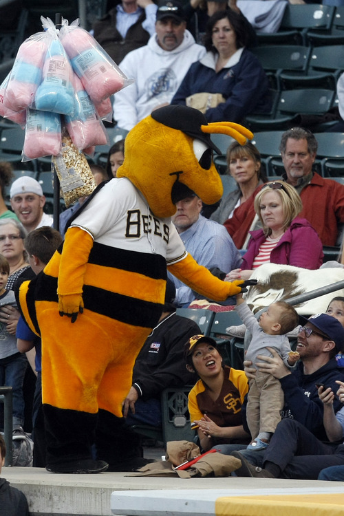 Chris Detrick  |  The Salt Lake Tribune
Bumble the Bee high fives a young fan during the game at Spring Mobile Ballpark Thursday April 4, 2013.
