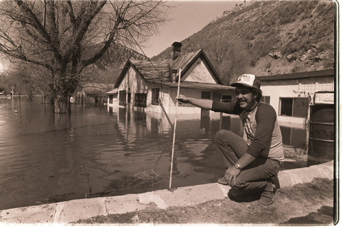(Salt Lake Tribune archives)

An unidentified man measures the water level that submerged Thistle, Utah after a massive landslide in April 1983.