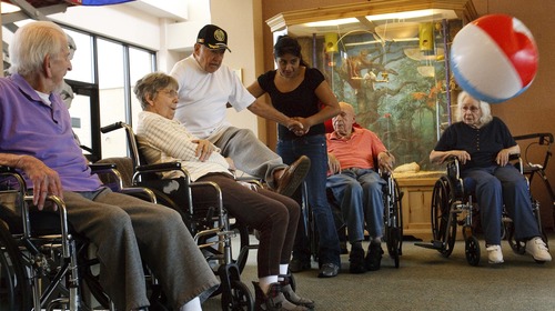 Leah Hogsten  |  The Salt Lake Tribune
Volunteer Erminia Martinez encourages veterans at the William E. Christofferson Veterans Nursing Home as they play balloon basketball and other active games. Veterans living at the home are part of a demographic group that makes up an increasing percentage of dying Americans. One in four people dying in the U.S. today is a vet and one in two men.