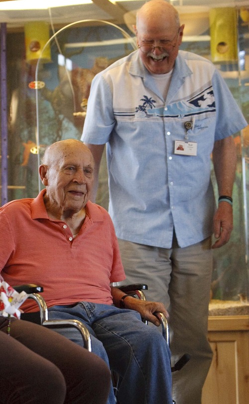 Leah Hogsten  |  The Salt Lake Tribune
WWII veteran John Whitby, 99, (left) laughs with recreation assistant Ked Kirkham at the William E. Christofferson Veterans Nursing Home as they play balloon basketball and other active games.  Veterans living at the home are part of a demographic group that makes up an increasing percentage of dying Americans.  One in four people dying in the U.S. today is a vet and one in two men.