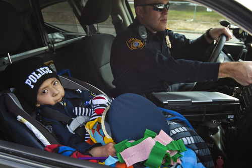 Chris Detrick  |  The Salt Lake Tribune
Brandon Royo, 9, rides in Granite School District Police Officer Michael Erickson's police car at Whittier Elementary in West Valley City. Royo, a second grade student at Whittier Elementary, is dying from medulloblastoma, a form of brain cancer.