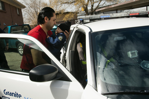 Chris Detrick  |  The Salt Lake Tribune
Luis Reyes puts his son Brandon Royo, 9, into a police car outside of his apartment in West Valley City Tuesday March 26, 2013. Royo, a second grade student at Whittier Elementary, is dying from medulloblastoma, a form of brain cancer.