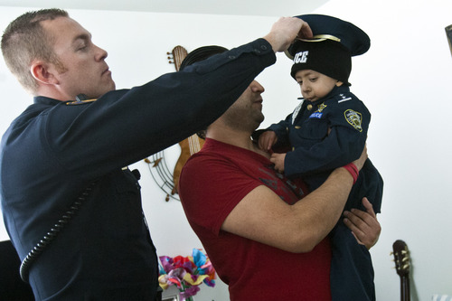 Chris Detrick  |  The Salt Lake Tribune
Granite School District Police Officer Michael Erickson gives a police hat to Brandon Royo, 9, at his apartment in West Valley City Tuesday March 26, 2013. Royo, a second grade student at Whittier Elementary, is dying from medulloblastoma, a form of brain cancer.
