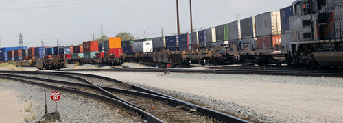 Al Hartmann  |  The Salt Lake Tribune  
Train pulling shipping containers parks at Union Pacific's intermodal shipping container hub at 5600 West and 10th South on July 12 2012.   The huge hub offloads containers from trains and trucks pickup the loads for delivery troughout the intermountain west.