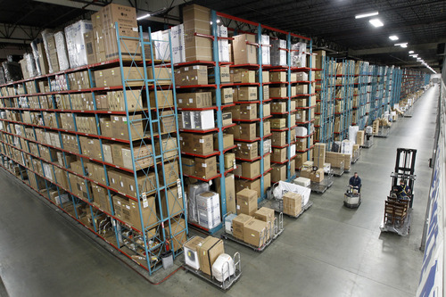 Al Hartmann  |  The Salt Lake Tribune
Lifts operate in the aisle of the one-quarter mile long  R.C. Willey Intermountain Distribution Center warehouse at 256 S. 5500 West in Salt Lake City.