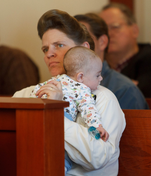 Trent Nelson  |  The Salt Lake Tribune
Joanna Jessop listens while holding an infant during a court hearing on the polygamous UEP land trust, Friday April 12, 2013 in Salt Lake City.