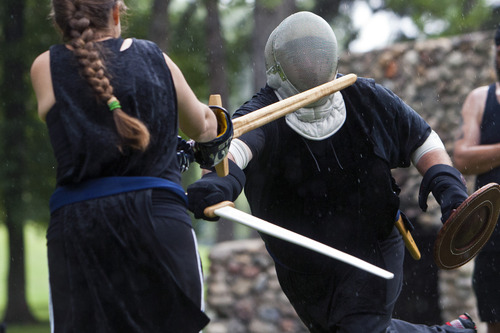 Chris Detrick  |  The Salt Lake Tribune
The United Clans Swordsman Association will have a sword fighting competition Saturday, April 13, 2013, at Liberty Park. In this photo from a 2012 event, Darrell Armstrong, in helmet, of West Valley City, competes against Heather Rentz, of Holladay.