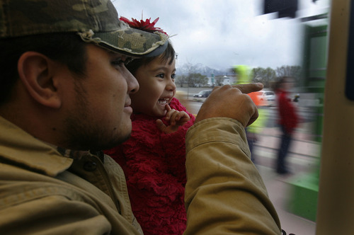 Scott Sommerdorf   |  The Salt Lake Tribune
Three year old Neyza Navarette takes her first train ride in the lap opf her father, Luis as they take the TRAX train down North Temple as it makes it's 
way down North Temple, Saturday, April 13, 2013.