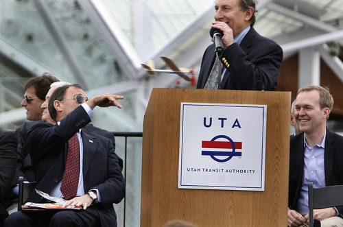 Scott Sommerdorf   |  The Salt Lake Tribune
Utah Governor Gary Herbert tosses a bals wood airplane at Salt Lake County Mayor Ben McAdams at the end of the "Food is Your Fare" event. At all stations one could donate a can of food to ride the new Airport Line before it opens,  Saturday, April 13, 2013.