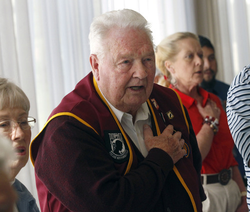 Al Hartmann  |  The Salt Lake Tribune
Robert L. Monson, who served in the Army Air Corp in World War II, pledges allegiance in a flag ceremony during a special luncheon that honored Utah men who were POWs in past wars.