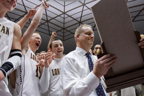 Trent Nelson  |  The Salt Lake Tribune
Lone Peak coach Quincy Lewis receives the championship trophy after beating Alta High School in the 5A basketball state championship game Saturday, March 2, 2013 in Ogden.