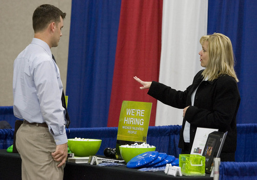 Paul Fraughton  |   Salt Lake Tribune
Jennifer Tate  of Progrexion answers questions about the company from Ben Washer a member of the Utah Air National Guard at the 2013  Hiring Our Heros Job Fair held at the Salt Palace Convention Center in conjunction with The Governor's Military and Family Summit                                                     
 Wednesday, April 17, 2013
