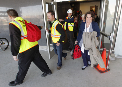 Al Hartmann  |  The Salt Lake Tribune
Employees with the State of Utah with their 72 hour backpack kits exit the state office building during the Great Utah Shake Out, an earthquake simulation excercise at the Utah State Capitol Wendesday April 17.