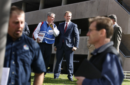 Scott Sommerdorf   |  The Salt Lake Tribune
Salt Lake County Mayor Ben McAdams, center, confers with his Emergency Services Director Jeff Graviett, left, as they speak about the progress of evacuating the County Government buildings during the course of the "Great American Shakeout" earthquake drill, Wednesday, April 17, 2013.