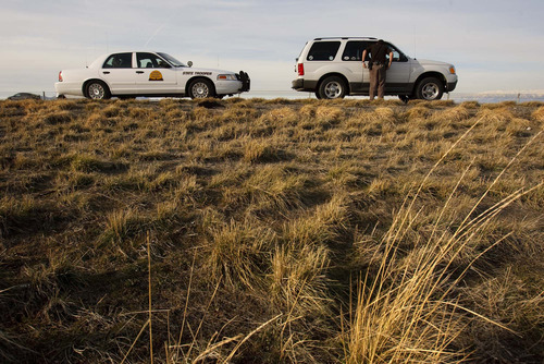 Trent Nelson  |  The Salt Lake Tribune

A trooper with the Utah Highway Patrol's criminal interdiction team questions a driver while patrolling I-80 looking for drug traffickers on March 11, 2009.