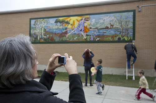 Lennie Mahler  |  The Salt Lake Tribune
Patricia Bullough photographs family at the old Olympus High School in front of a 26-foot by 9-foot tile painting she created with her late sister, Rebecca Bullough-Horne, while Patricia taught art at the high school. The painting, which has served as a memorial to the family since Rebecca's passing in 1998, is to be demolished now that the new Olympus High has been built.