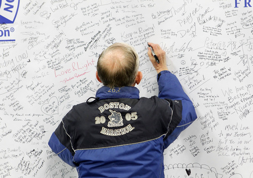 Al Hartmann  |  The Salt Lake Tribune
Ole Holsti, 79, of Salt Lake City, a veteran of nine Boston marathons signs a banner of solidarity and hope to the city of Boston at the Salt Palace Convention Center as he registers for the Salt Lake City Marathon Friday April 19.  He's run four Salt Lake Marathons and will be participating Saturday.