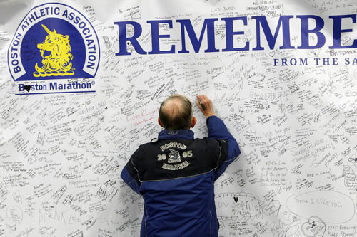 Al Hartmann  |  The Salt Lake Tribune
Ole Holsti, 79, of Salt Lake City, a veteran of nine Boston marathons signs a banner of solidarity and hope to the city of Boston at the Salt Palace Convention Center as he registers for the Salt Lake City Marathon Friday April 19.  He's run four Salt Lake Marathons and will be participating Saturday.