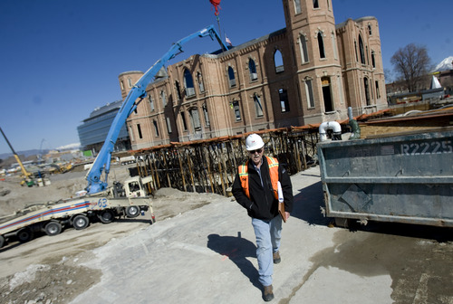Kim Raff  |  The Salt Lake Tribune
A construction worker walks around the Provo City Center Temple construction site in Provo on April 18, 2013. The workers dug down nearly 40 feet under the temple and supported the building's structure on metal pylons to reconstruct the foundation.