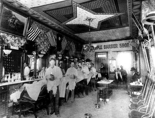 (Salt Lake Tribune archive)
Temple barbershop at 14 W. South Temple in Salt Lake in 1892. The haircut was 2-bits and for an extra quarter, you could get a shampoo or singe in this "high toned tonsorial parlor."