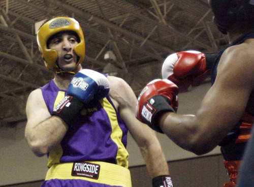 FILE - In this May 4, 2009 file photo,  Tamerlan Tsarnaev, left, fights Lamar Fenner of Chicago, in the 201 weight class, during the 2009 Golden Gloves National Boxing Tournament at the Salt Palace, Monday, May 4,  2009. Tsameav was identified as a suspect in the Boston Marathon bombings.  Tsarnaev, who had been known to the FBI as Suspect No. 1 and was seen in surveillance footage in a black baseball cap, was killed overnight Thursday during a getaway attempt, officials said. On Friday, April 19, 2013, thousands of officers were swarming the streets in and around Boston hunting for Tsarnaev's younger brother, Dzhokhar Tsarnaev, 19. (AP Photo/The Salt Lake Tribune, Rick Egan)  DESERET NEWS OUT; LOCAL TV OUT; MAGS OUT