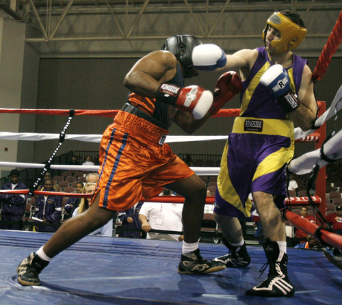 FILE - In this May 4, 2009 file photo,  Tamerlan Tsarnaev, right,  fights Lamar Fenner of Chicago, in the 201 weight class, during the 2009 Golden Gloves National Boxing Tournament at the Salt Palace, Monday, May 4,  2009. Tsameav was identified as a suspect in the Boston Marathon bombings.  Tsarnaev, who had been known to the FBI as Suspect No. 1 and was seen in surveillance footage in a black baseball cap, was killed overnight Thursday during a getaway attempt, officials said. On Friday, April 19, 2013, thousands of officers were swarming the streets in and around Boston hunting for Tsarnaev's younger brother, Dzhokhar Tsarnaev, 19. (AP Photo/The Salt Lake Tribune, Rick Egan)  DESERET NEWS OUT; LOCAL TV OUT; MAGS OUT
