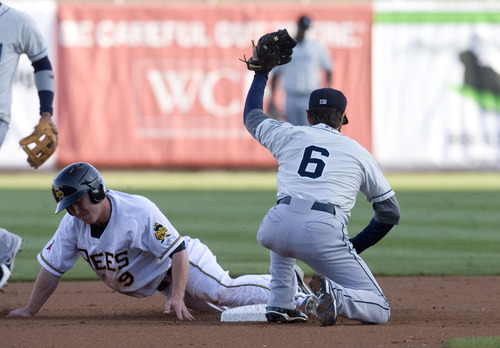 Kim Raff  |  The Salt Lake Tribune
(left) Salt Lake Bees player Matt Young is tagged out at second by Tacoma Rainiers player Nick Franklin during a game at Spring Mobile Ballpark in Salt Lake City on April 21, 2013.