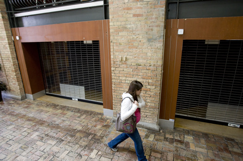 Kim Raff  |  The Salt Lake Tribune
A patron walks by an empty storefront in the Trolley Square shopping center in Salt Lake City on April 22, 2013. Khosrow Semnani, the new owner of Trolley Square, is trying to turns things around in the struggling shopping center.