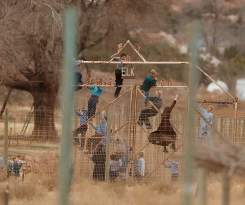 Trent Nelson  |  The Salt Lake Tribune
Children climbing a fence at what was once a thriving community zoo, Friday November 30, 2012 in Hildale.