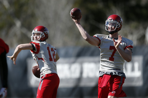 Chris Detrick  |  The Salt Lake Tribune
Utah quarterback Travis Wilson and Adam Schulz throw the ball during spring practice Tuesday, March 19, 2013.