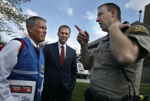 Scott Sommerdorf   |  The Salt Lake Tribune
Salt Lake County Mayor Ben McAdams, center, meets with his Emergency Services Director Jeff Graviett, left, as Deputy Craig Tischer, right, gives the two men an update on the progress of evacuating the County Government buildings during the course of the "Great American Shakeout" earthquake drill, Wednesday, April 17, 2013.