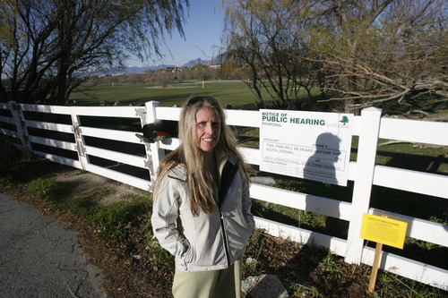 Rick Egan  | The Salt Lake Tribune 

Angela Healy stands near the northern stub accesses the Jordan River Parkway which is across the street from her home in Riverton, Thursday, April 18, 2013.  Residents of Reeves Lane in Riverton have petitioned the addition of a throughway to a dead end on their northern end, the result of and Ivory Homes housing development in planning.