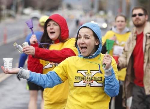 Leah Hogsten  |  The Salt Lake Tribune
Volunteers and roomates Melissa Marsh (left) and Lacey Johnson cheer on the runners at the 20-mile mark. Soggy conditions hardly dampened the festive mood the 7,000 runners participating in the Salt Lake City Marathon, which started Saturday morning, April 20, 2013, following a moment of silence in honor of those harmed five days earlier at the Boston Marathon bombing