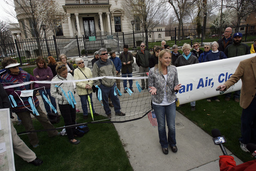 Francisco Kjolseth  |  The Salt Lake Tribune
Cecilee Price-Huish of Bountiful joins other Utah citizens to push for clean air, clean energy and a clean future as they gather in front of the governor's mansion in Salt Lake City on Earth Day, Monday April 22, 2013. The group was asking the governor to be more responsive in addressing air pollution concerns and embracing clean energy.