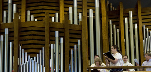 Kim Raff  |  The Salt Lake Tribune
Members of the choir of St. Ambrose Catholic Church sing as the newly installed Roper Memorial Pipe Organ is played in the sanctuary during Easter Sunday Mass in Salt Lake City on March 31, 2013.