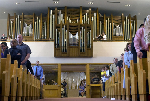 Kim Raff  |  The Salt Lake Tribune
People stand and sing as the newly installed Roper Memorial Pipe Organ plays a hymn at St. Ambrose Catholic Church during Easter Sunday Mass in Salt Lake City on March 31, 2013.
