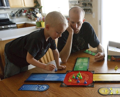 Leah Hogsten  |  The Salt Lake Tribune
Jeremy York plays a board game at home with his son Keagan, 5, Wednesday, April 24, 2013. York was scheduled to go to work as a haul truck driver at Kennecott Copper Mine but had his job offer rescinded after the landslide covered half of the pit.