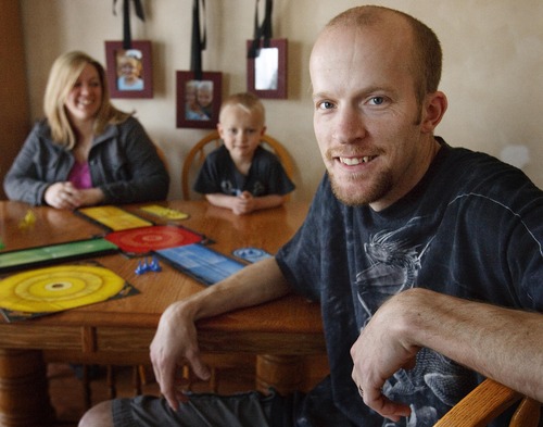 Leah Hogsten  |  The Salt Lake Tribune
Jeremy York plays a board game at home with his wife Holly and son Keagan, 5, Wednesday, April 24, 2013. York was scheduled to go to work as a haul truck driver at Kennecott Copper Mine but had his job offer rescinded after the landslide covered half of the pit.