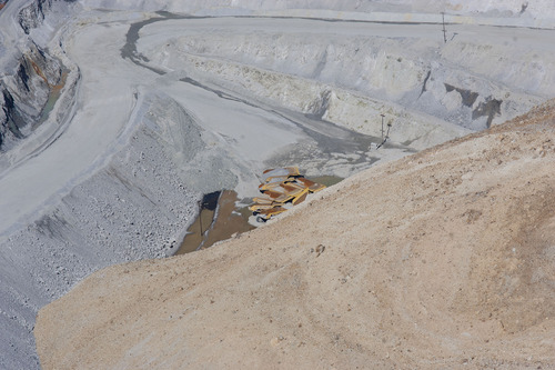 Al Hartmann  |  The Salt Lake Tribune

Buried dump trucks stick out of the dirt at the bottom of the slide area at Kennecott on Thursday, April 25, 2013.