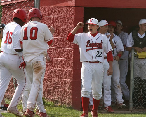 Paul Fraughton  |   Salt Lake Tribune
After scoring runs, East High's Kory Rush,16, and Parker Van Dyke ,10, are congratulated in the dug out by teammate Easton Biddulph. East defeated Woods Cross 12 to 10 at East High's field.                                                    
 Thursday, April 25, 2013