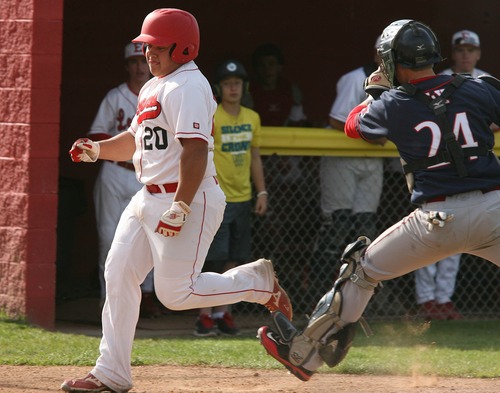 Paul Fraughton  |   Salt Lake Tribune
East High's Gabe Guitierrez  runs past Woods Cross catcher Brady Cowley  to score a run.  East defeated Woods Cross 12 to 10 at East High's field.                                                    
 Thursday, April 25, 2013