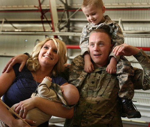 Leah Hogsten  |  The Salt Lake Tribune
Katy and Paul Gibbs pose for a family picture with their sons Aiden and Everett, 2 months. Twenty-seven babies, including two sets of twins, were born to wives and partners of returning soldiers of the Utah National Guard's 624th Engineer Company, 1457th Engineer Battalion,Thursday, April 25, 2013, during their 10-month deployment to Afghanistan.