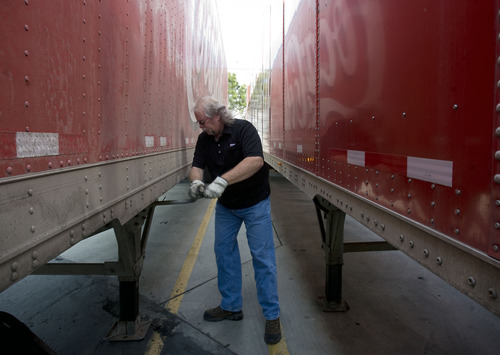 Kim Raff  |  The Salt Lake Tribune
Craig Vorwaller, a Ryder truck driver for Swire CocaCola, hooks up a trailer to his truck before heading out on a transport in West Valley City on April 25, 2013. Vorwaller has been recognized by Ryder for driving 3.1 million miles over his 34-year professional driving career.
