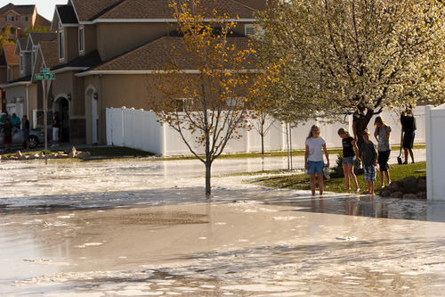 Trent Nelson  |  The Salt Lake Tribune
A canal breach sent water flooding into a Murray neighborhood Saturday, April 27, 2013.