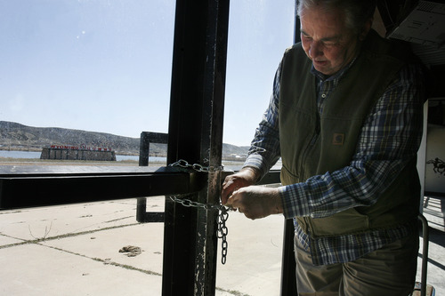 Scott Sommerdorf   |  The Salt Lake Tribune
Contractor Paul Nelson opens one of the locked and chained doors at Wyoming Downs, Thursday, April 25, 2013. The track has been dormant for 4-5 years, but brothers Eric and Paul Nelson are working to bring it back to life.