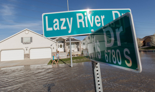 Trent Nelson  |  The Salt Lake Tribune
Flood waters from the breached North Jordan Canal engulf Lazy River Drive, Saturday, April 27, 2013 in Murray.
