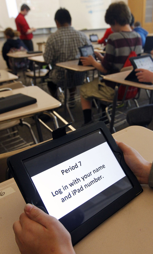 Al Hartmann  |  The Salt Lake Tribune
North Davis Junior High School seventh-graders log onto their assigned iPad at the beginning of Kelland Davis' math class.