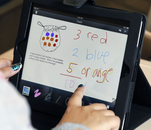 Al Hartmann  |  The Salt Lake Tribune
A North Davis Junior High School seventh-grader works out a math problem on her iPad.